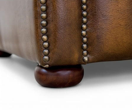 Cambridge Chesterfield Sofa corner detail with antique brass studs and wooden bun foot